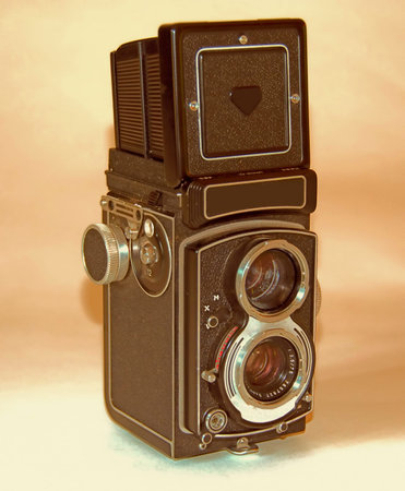 A photo of a German-made vintage camer on a shadowy background with the viewfinder extended