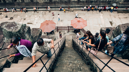 Angkor Wat Siem Reap, Cambodia - May 27, 2018 : Tourists are climbing on the stair to the top of Angkor Wat.のeditorial素材