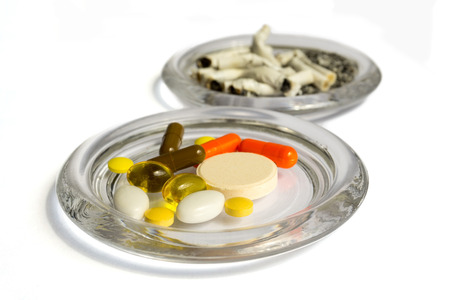 Pills and cigarette buttsの写真素材