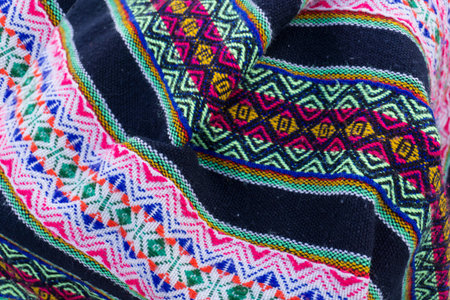 Ancient Andean colored fabrics woven by hand as background