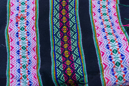 Ancient Andean colored fabrics woven by hand as background