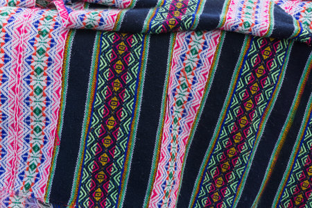 Ancient Andean colored fabrics woven by hand as background