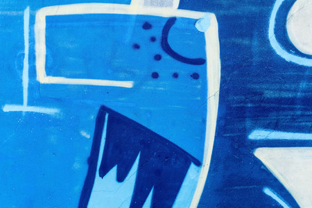 Detail of a graffiti art on a wall. Wall painted in different colors. Abstract blue background.の写真素材