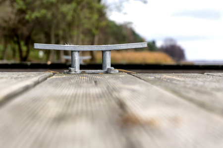 Wooden pier with cleat. Nobody. Selective focus