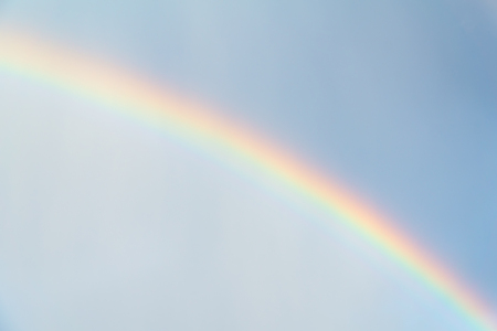 Rainbow in blue sky after the rain - physical phenomenon - as backgroundの写真素材
