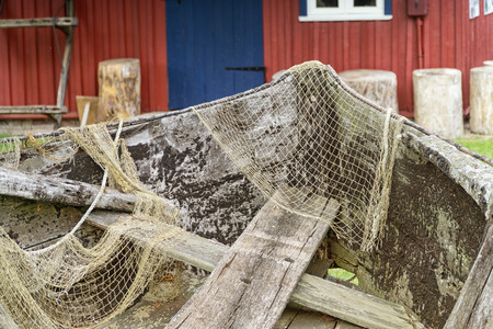 Old wooden fishing boat with drying up fishing nets.の写真素材