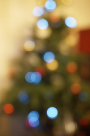 Blured christmas tree with colorful magic lightsの写真素材
