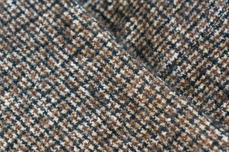 Wool or Tweed texture background. Fabric  checkered in brown. Selective focus.の写真素材