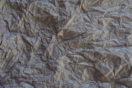Texture of faded dark gray purple wrinkle paper as backgroundの写真素材