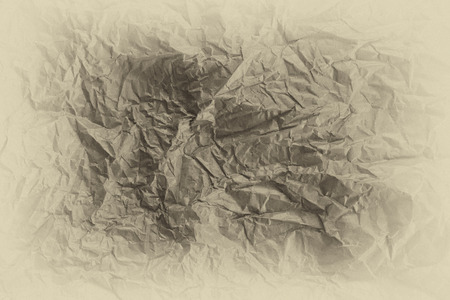 Texture of beige wrinkle paper with vignette effect as backgroundの写真素材