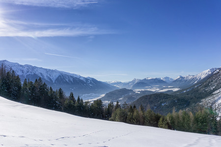 Winter mountains landscape track and blue sky in sunny day. Tirol, Alps, Austriaの写真素材