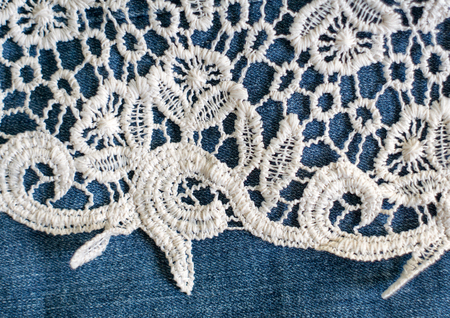 Openwork fabric lace border on denim backgroundの写真素材