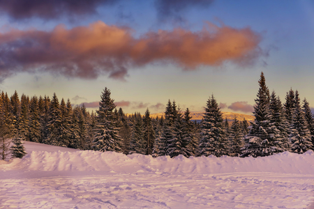 Winter mountains landscape. Sunset - dramatic clouds on blue sky. Jizera Mountains, Czech Republic, Europe.の写真素材