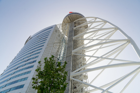 LISBON, PORTUGAL -  SEPTEMBER 1, 2018: Vasco da Gama tower in the Park of Nations (Parque das Nacoes) in the city of Lisbon, in Portugal. Palm leaves in the foreground.のeditorial素材