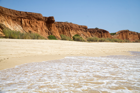 High cliffs along Falesia Beach and The Atlantic Ocean in Albufeira, Algarve, Portugal. Sunny summer day, blue sky.の写真素材