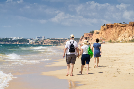 Senior couple walking on the beach on the summer sunny dayの写真素材