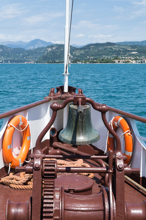 Bell on bow of ship on Garda Lake in sunny summer day, Italy, Europe. Concept of summer leisure.の写真素材