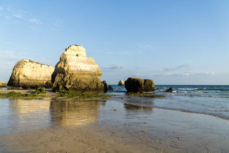 Rock formations on a Praia da Rocha in Portimao, Algarve region, Portugal. Late afternoon of sunny summer day.の写真素材