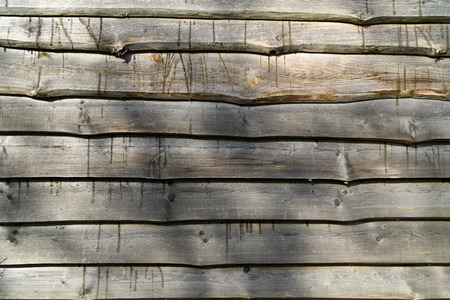 Fence from horizontal raw old gray old boards. Wood texture background.の写真素材