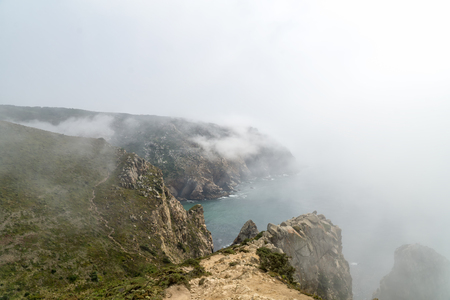 Cape Roca (Cabo da Roca) cliffs in fog. The rocks are obscured by clouds or fog. Cape Roca is most western part of Europe, Portugal.の写真素材