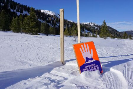 Avalanche area sign alerts winter travelers to possible snow slides in the Alps, Salzburger Land in Austria, Europe.の写真素材