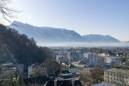 Layer of smog blankets over the Salzburg, Austria, Europa. With Alps summits in the background.の写真素材