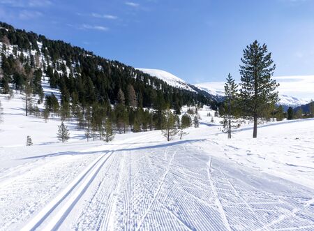 Winter landscape with a road with a cross-country trail in the Schonfeld area, Salzburger Lungau, Austria, Europe. Winter background.の写真素材