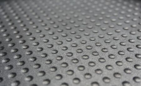 Metallic background with dot pattern. Selective focus. Industrial, abstract background.の写真素材