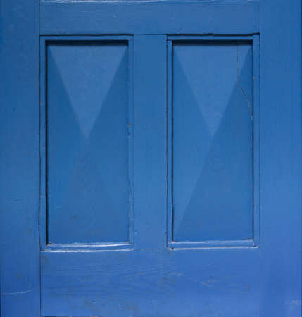 Detail of an old wooden blue painted door. Blue background. Blue rectangular frame.の写真素材