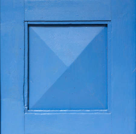 Detail of an old wooden blue painted door. Blue background. Blue square frame.の写真素材