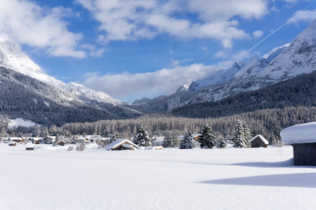 Ehrwald Valley, Tirol, Austria. Winter mountain landscape, Sunny day with white clouds on blue sky.の写真素材