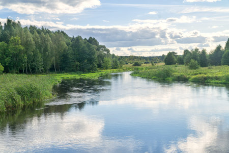 Landscape Suprasl River in Podlasie, Poland. The river flows among meadows and forests, the blue sky...