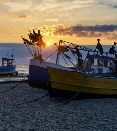 Fishing boats on the beach at sunset: Baltic Sea, Western Pomerania, Poland, Europe.の写真素材