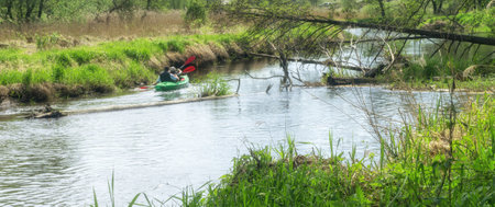 Wild river kayaking in spring. Single boat with two people. Drweca River, Poland, Europe.の写真素材