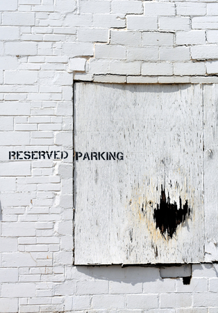White brick wall and boarded window abandoned.の写真素材