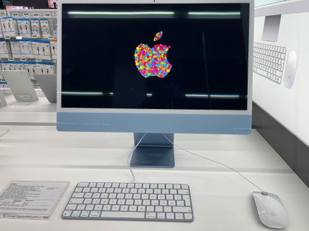 Darmstadt, Germany - August 06th 2021: A german photographer visiting a Media Market in a shopping mall, collecting information and taking pictures of the all new Apple iMac 2021 in blue.のeditorial素材