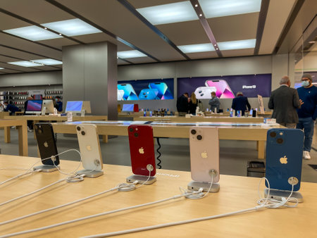 Cologne, Germany - October 01st 2021: A german photographer comparing and testing the new iPhone 13 as well as iPhone 13 Pro and iPhone 13 Mini in an Apple Store.のeditorial素材