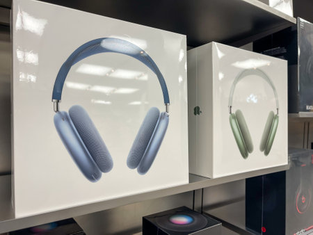 Cologne, Germany - October 01st 2021: A german photographer comparing and testing the new Airpod Max in different colors in an Apple Store.のeditorial素材