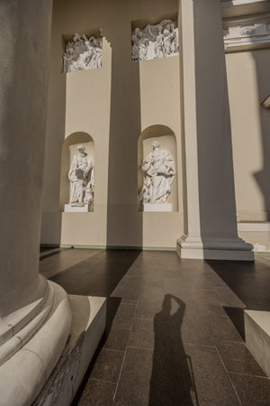 Vilnius, Lithuania - July 17th 2024: A German photographer visiting Vilnius, taking pictures of sights of the city, here the cathedral with religious statues at the entrance.のeditorial素材