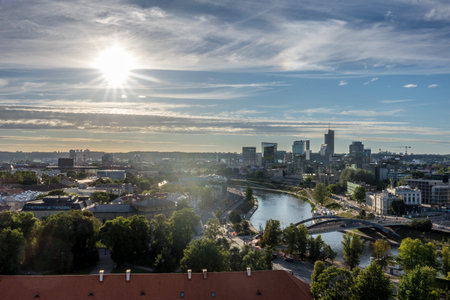 Vilnius, Lithuania - July 17th 2024: A German photographer visiting Vilnius, taking pictures of sight of the city, here the view over the river Vilnia to the business district.のeditorial素材