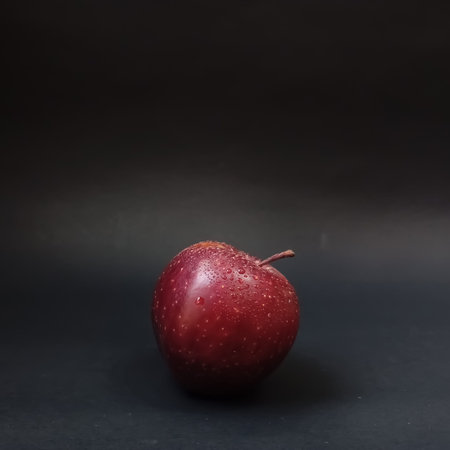 Red apple fruit on black background