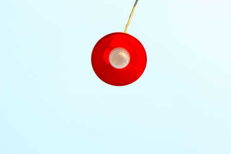 white bulb into a red rounded plastic bowl top of the rowの写真素材