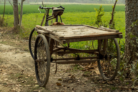 Many old and rusty iron and wooden vans on the village roadの写真素材