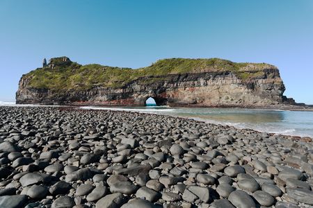 A coastal rock formation in the Wild Coast, South Africa, with a hole eroded by wave actionの写真素材