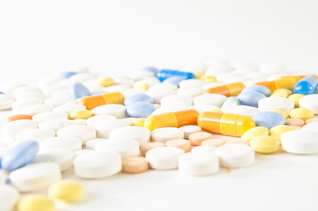 Variety of colorful pills on white background. Medical / pharmaceutical backgroundの写真素材