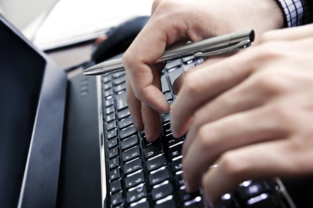 Hands on a laptop keyboard - a journalist, writer or a programmer at workの写真素材