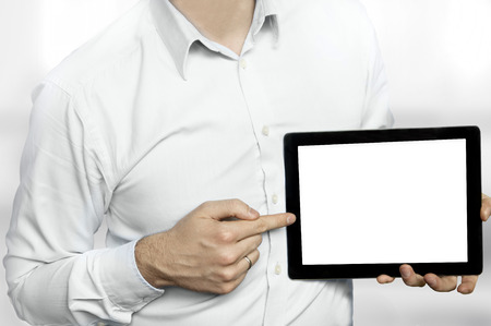 Man in shirt pointing finger at a tablet computer with blank displayの写真素材