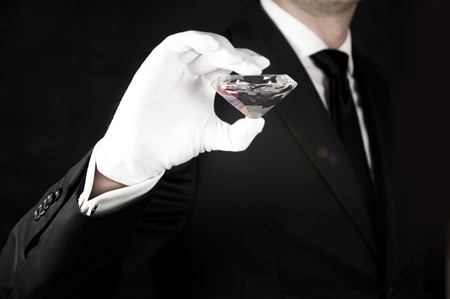 Big gem in hand of an elegant jewelerの写真素材