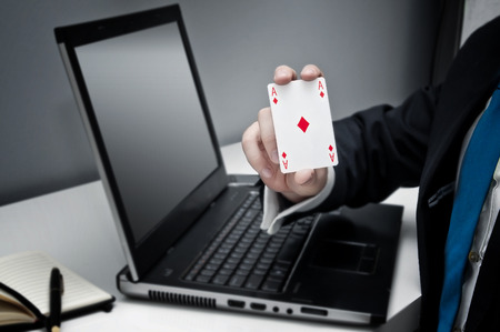 Businessman holding ace of diamonds playing card - concept of success in businessの写真素材