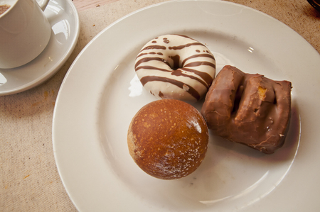 Sweet dessert - donuts and coffee. Pastry on a plateの写真素材